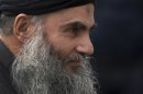 Abu Qatada arrives back at his residence in London after being freed from prison, Tuesday, Nov. 13, 2012. The radical Islamist cleric described by prosecutors as a key al-Qaida operative in Europe was freed from prison Tuesday after a court ruled he cannot be deported from Britain to Jordan to face terrorism charges. Britain's government has attempted since 2001 to expel Abu Qatada, a Palestinian-born Jordanian cleric convicted in Jordan over terror plots in 1999 and 2000, but has been repeatedly thwarted by European and British courts. (AP Photo/Matt Dunham)