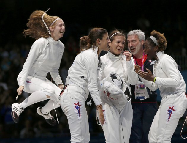 Fencing team of the U.S. celebrate their victory at the end of the women's eppe team bronze medal fencing competition against Russia at the London 2012 Olympic Games