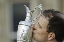United States' Zach Johnson kisses the trophy as he poses for photographers after winning a playoff after the final round at the British Open Golf Championship at the Old Course, St. Andrews, Scotland, Monday, July 20, 2015. (AP Photo/David J. Phillip)
