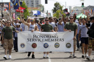 FILE - This July 16, 2011 file photo shows members of the military marching in the Gay Pride Parade in San Diego. The Defense Department on Thursday, July 19, 2012 announced it is allowing service members to march in uniform in a gay pride parade for the first time in U.S. history. The department said it was making the exception for Saturday's Gay Pride Parade in San Diego because organizers had encouraged military personnel to march in their uniform and the event was getting national attention. (AP Photo/Gregory Bull, File)