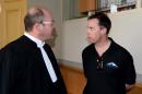 British ski instructor Simon Butler (R) speaks with his counsel Philippe Planes as he attends on April 7, 2014 a hearing at the court in Bonneville, southeastern France