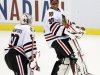 Chicago Blackhawks goalie Ray Emery (30) jokes with goalie Corey Crawford (50) after a 2-1 win over the Detroit Red Wings in overtime of an NHL hockey game on Sunday, March 3, 2013, in Detroit. (AP Photo/Duane Burleson)