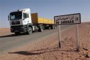 A truck passes by a road sign in In Amenas