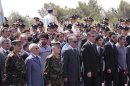 Syrian officials attend a funeral for Syrian President Assad's senior security officials in Damascus