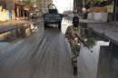 A tribesman, fighting alongside Iraqi police forces, patrols a street in the city of Ramadi on January 30, 2014