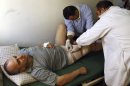 Palestinian lawmaker Shami Al-Shami, 47, is treated by medics for gun wounds sustained outside his home in the West Bank town of Jenin, Sunday, July 1, 2012. Al-Shami said Sunday he has been shot twice in the leg by assailants as he got out of his car outside his home. Jenin once served as a model for Palestinian law and order, but has experienced a wave of brazen attacks by gunmen over the past year. (AP Photo/Mohammed Ballas)