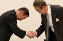 Toshio Tamogami, former air defence forces chief of staff (L), shakes hands with former Tokyo governor Shintaro Ishihara after Ishihara voiced his support in a speech for Tamogami's candidacy in the Tokyo governor elections on January 7, 2014