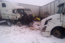 This photo provided by the Iowa State Patrol shows the scene of a 25-vehicle pileup that killed three people Thursday, Dec. 20, 2012 north of Des Moines, Iowa. Authorities said drivers were blinded by blowing snow and didn't see vehicles that had slowed or stopped on Interstate 80 about 60 miles north of Des Moines. A chain reaction of crashes involving semitrailers and passenger cars closed down a section of the highway. (AP Photo/Iowa State Patrol)
