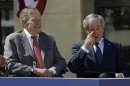 Former president George W. Bush wipes a tear after his speech during the dedication of the George W. Bush Presidential Center Thursday, April 25, 2013, in Dallas. Former president George H.W. Bush is at left. (AP Photo/David J. Phillip)