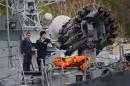 Sailors stand next to a weapons system onboard a Russian Navy vessel anchored at a navy base in the Ukrainian Black Sea port of Sevastopol in Crimea