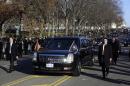 President Barack Obama and first lady Michelle Obama ride in the presidential limousine during the 57th Presidential Inauguration parade Monday, Jan. 21, 2013, in Washington. (AP Photo/Charles Dharapak)