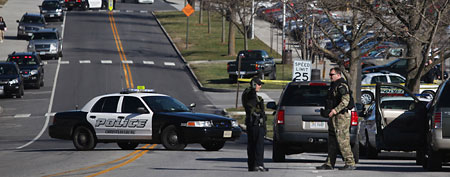 Police officers block a road on the Virginia Tech campus in Blacksburg, Va., after a gunman killed a police officer and another person Thursday, Dec. 8, 2011.  (AP)