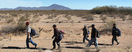 Undocumented Mexican immigrants walk through the Sonoran Desert after illegally crossing the U.S.-Mexico border border (Photo by John Moore/Getty Images)