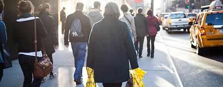 A shopper carries her purchases as she walks down Fifth Avenue on 'Black Friday' on November 25, 2011, in New York City. (Photo by Michael Nagle/Getty Images)