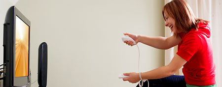Woman playing Nintendo Wii. (Getty Images)