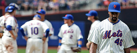 New York Mets relief pitcher Manny Acosta heads for the dugout after being removed in the eighth inning of a baseball game against the Milwaukee Brewers, Sunday, Aug. 21, 2011, in New York. (AP Photo/Mark Lennihan)