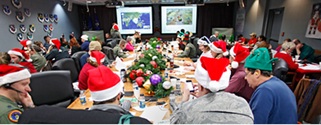 In this Dec. 24, 2010 photo, volunteers take phone calls and answer emails at the Santa Tracking Operations Center at Peterson Air Force Base near Colorado Springs, Colo. (AP Photo/Ed Andrieski, File)