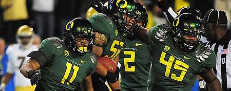 Oregon Ducks linebacker Dewitt Stuckey (52) is congratulated after recovering the football on a fumble by UCLA Bruins quarterback Kevin Prince (not pictured) during the first quarter of the Pac-12 Championship game at Autzen Stadium.  (Kyle Terada-US PRESSWIRE)