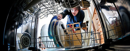 Man loading dishwasher. (ThinkStock)