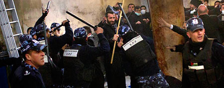 Palestinian police officers intervene in a fight that erupted between Greek Orthodox and Armenian clergymen during the cleaning of the Church of the Nativity. (AP/Bernat Armangue)