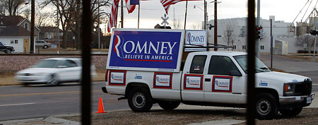 A supporter's decorated vehicle is seen outside a campaign stop for Republican presidential candidate, former Massachusetts Gov. Mitt Romney, Dec. 31, 2011, in Le Mars, Iowa. (AP Photo/Eric Gay)
