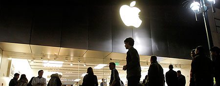 People stand outside the Apple Store in Santa Monica, Calif. (AP Photo/Jae C. Hong)