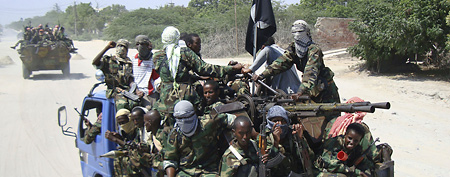 Hard-line Islamist al-Shabab fighters riding a truck during a military exercise in the Suqaholaha neighborhood of in northern Mogadishu, Somalia on Friday, Jan. 1, 2010. (AP Photo/John Moore, Farah Abdi Warsameh, File)