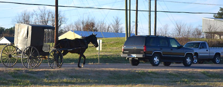 In this photo taken Dec. 8, 2011, an unmarked Amish buggy rides on U.S. 45 near Mayfield, Ky. (AP Photo/Dylan Lovan)