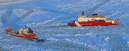 The Coast Guard Cutter Healy, right, approaches the Russian-flagged tanker Renda while breaking ice around the vessel 97 miles south of Nome, Alaska, Jan. 10, 2012. (AP Photo/U.S. Coast Guard/Petty Officer 1st Class Sara Francis)