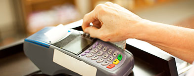 Customer using a debit card (Thinkstock)
