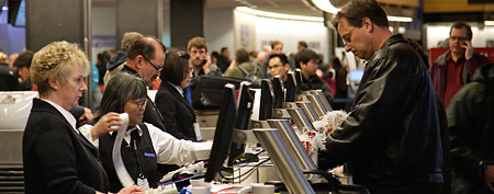 Workers at a Delta Air Lines ticket counte. (AP Photo/Ted S. Warren)