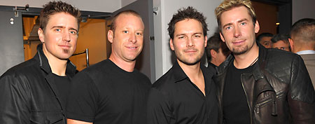 Musicians Daniel Adair, Mike Kroeger, Ryan Peake and Chad Kroeger of the band Nickelback backstage at the 2011 American Music Awards held at Nokia Theatre L.A. LIVE on November 20, 2011 in Los Angeles, California. (Photo by John Shearer/AMA2011/Getty Images for AMA)