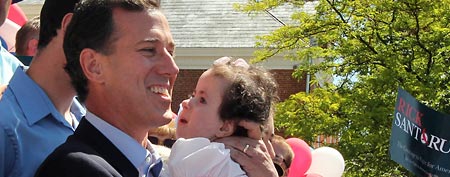 Rick Santorum holds his daughter Isabella in June 2011 (AP/Gene J. Puskar, File)