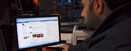 A Syrian man connects on his Facebook account at an internet cafe, in Damascus, Syria, on Tuesday Feb. 8, 2011. (AP Photo/Muzaffar Salman)