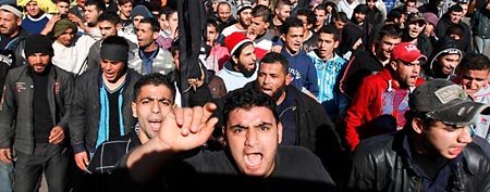 Lebanese and Syrians shout slogans as they march during a protest in Tripoli, northern Lebanon, February 4, 2012,   against an attack by Syrian President Bashar al-Assad's forces on the Syrian city of Homs. (Reuters)