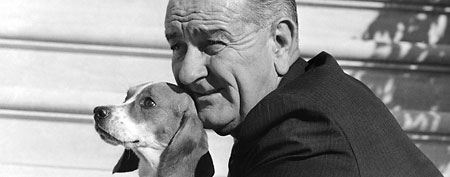 President Lyndon Johnson poses with Freckles, mother of five Beagle pups at the White House in Washington, Nov. 4, 1966.  (AP Photo/John Rous)
