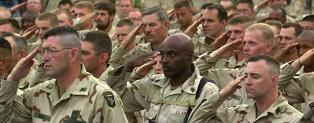 U.S.and Canadian troops salute to soldiers who died since Operation Enduring Freedom was launched on Monday May 27, 2002 at Kandahar Airport, Afghanistan. (AP Photo/Eugene Hoshiko)
