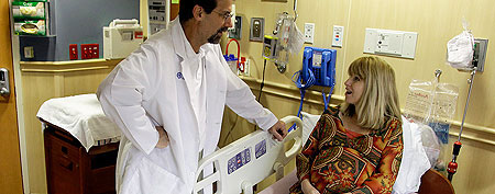 Tammy Gerencser, 42, right, talks with Dr. Michael Cacciatore, left, at Florida Hospital, Monday, Feb. 27, 2012, in Orlando, Fla. Gerencser is scheduled to have a C-section, Wednesday, Feb. 29. Most people born on Feb. 29 relish their uniqueness, and mothers with scheduled C-sections don't shun the day. A hospital in Florida reports an uptick in C-sections for the day. (AP Photo/Lynne Sladky)