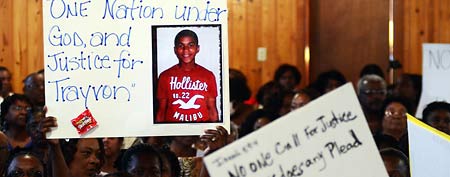 People hold up signs before an NAACP town hall meeting about the shooting death of Trayvon Martin as pictured at Allen Chapel A.M.E. Church in Sanford, Florida March 20, 2012. (REUTERS/David Manning)