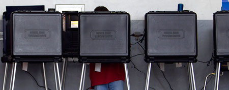 Casting votes in voter booths. (J Pat Carter/AP)