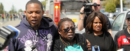 Marilyn Daniels, center, an employee at Oikos University, is comforted following a shooting on Monday, April 2, 2012. (AP/Noah Berger)