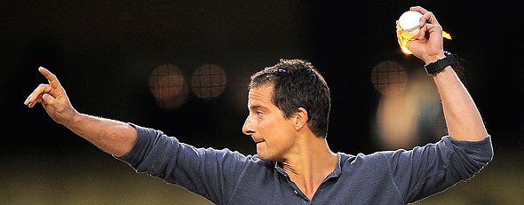 "Man vs. Wild" host Bear Grylls throws out the ceremonial first pitch with a ball that he lit on fire prior to the Pittsburgh Pirates baseball game against the Los Angeles Dodgers, Thursday, April 12, 2012, in Los Angeles. (AP Photo/Mark J. Terrill)