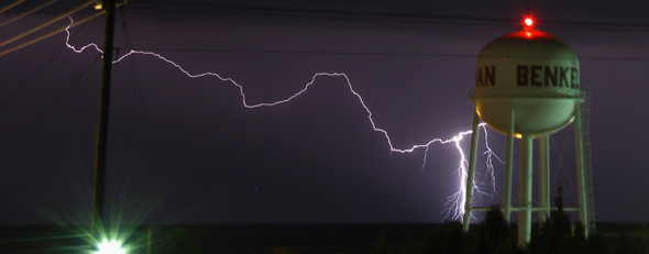 A lightning strike is seen near the water tower of Benkelman, Nebraska on April 12, 2012. (REUTERS/Gene Blevins)