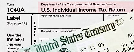 Tax form with refund check (Thinkstock)