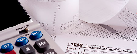 Adding machine with tax forms (Thinkstock)