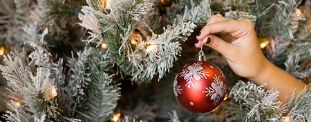 Hanging Christmas ornament on snow-flocked tree (Thinkstock)