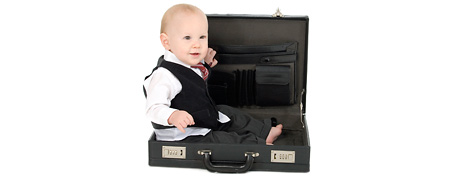 Baby dressed in suit, sitting in briefcase (Thinkstock)