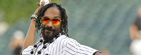 Snoop Dogg strikes famous poses after first pitch in Chicago (AP Photo)