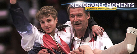 USA's Kerri Strug is carried by her coach, Bela Karolyi, as she waves to the crowd on her way to receiving her gold medal for the women's team gymnastics competition, at the Centennial Summer Olympic Games in Atlanta on Tuesday, July 23, 1996. Strugg has two torn ligaments and a sprained ankle from the vault competition. (AP Photo/John Gaps III)
