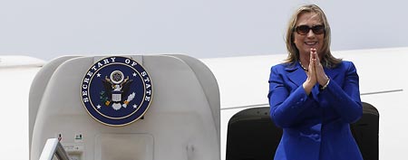 U.S. Secretary of State Hillary Rodham Clinton boards her plane at Kolkata in route to Delhi. Clinton has broken a record by traveling to 100 countries in her tenure as secretary of state. (AP Photo/Shannon Stapleton, Pool)